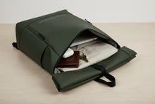 Charger l'image dans la galerie, Sac à dos vert olive TrekkerSS ouvert avec ordinateur, clés, portefeuille et vêtement plié sur surface claire
